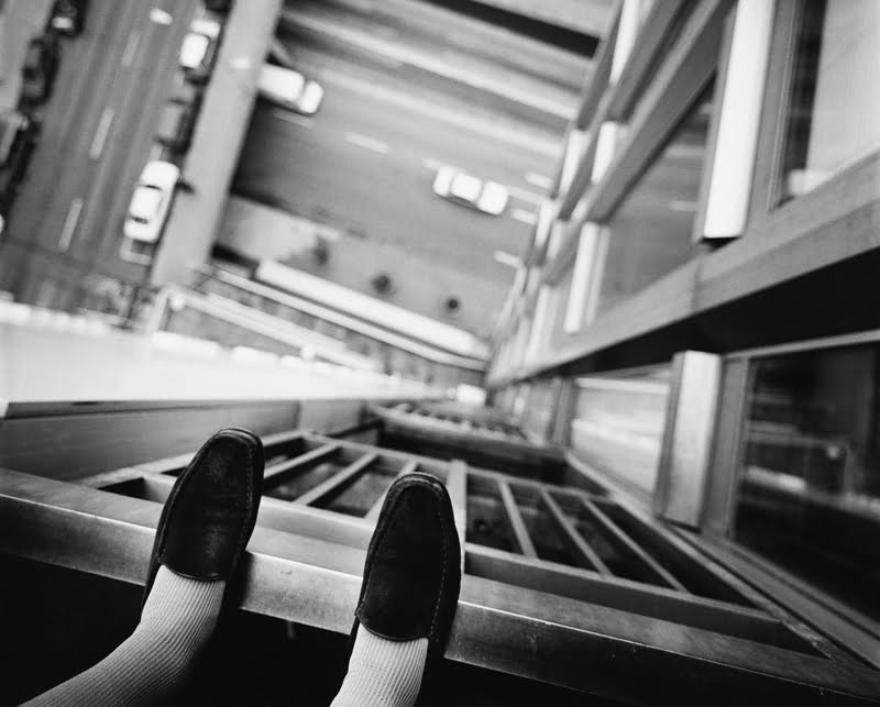 girl standing on the edge of a tall building possible suicide